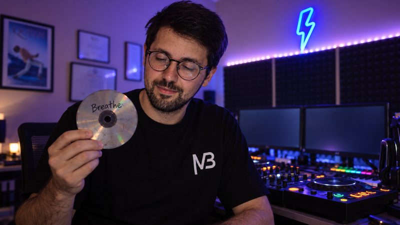 Melo in his studio holding the CD